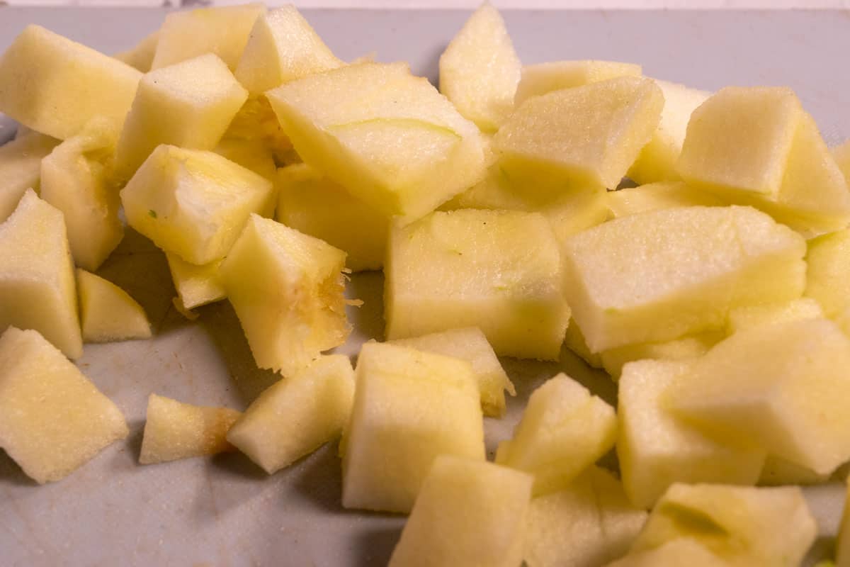 The skin has been removed and the apple has been chopped into cubes. 