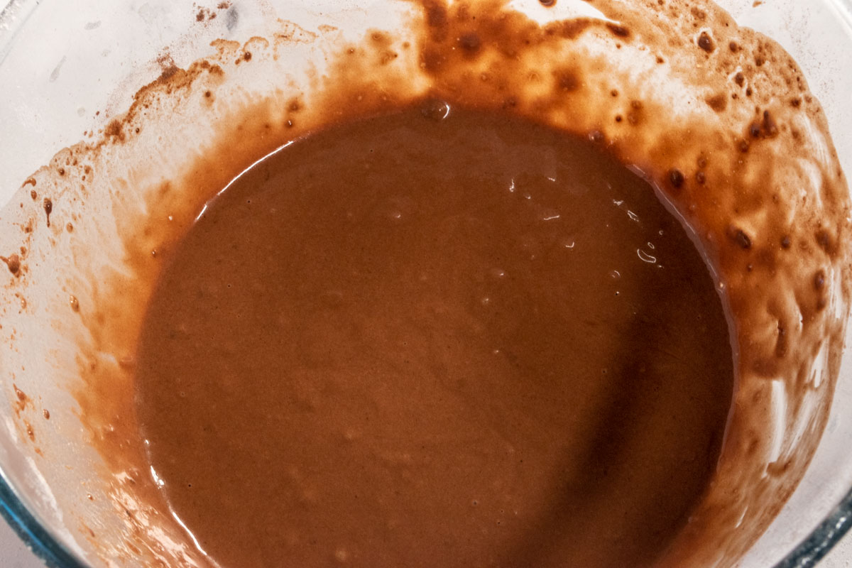 The dry and wet ingredients have been folded together to make a smooth chocolate pancake batter.