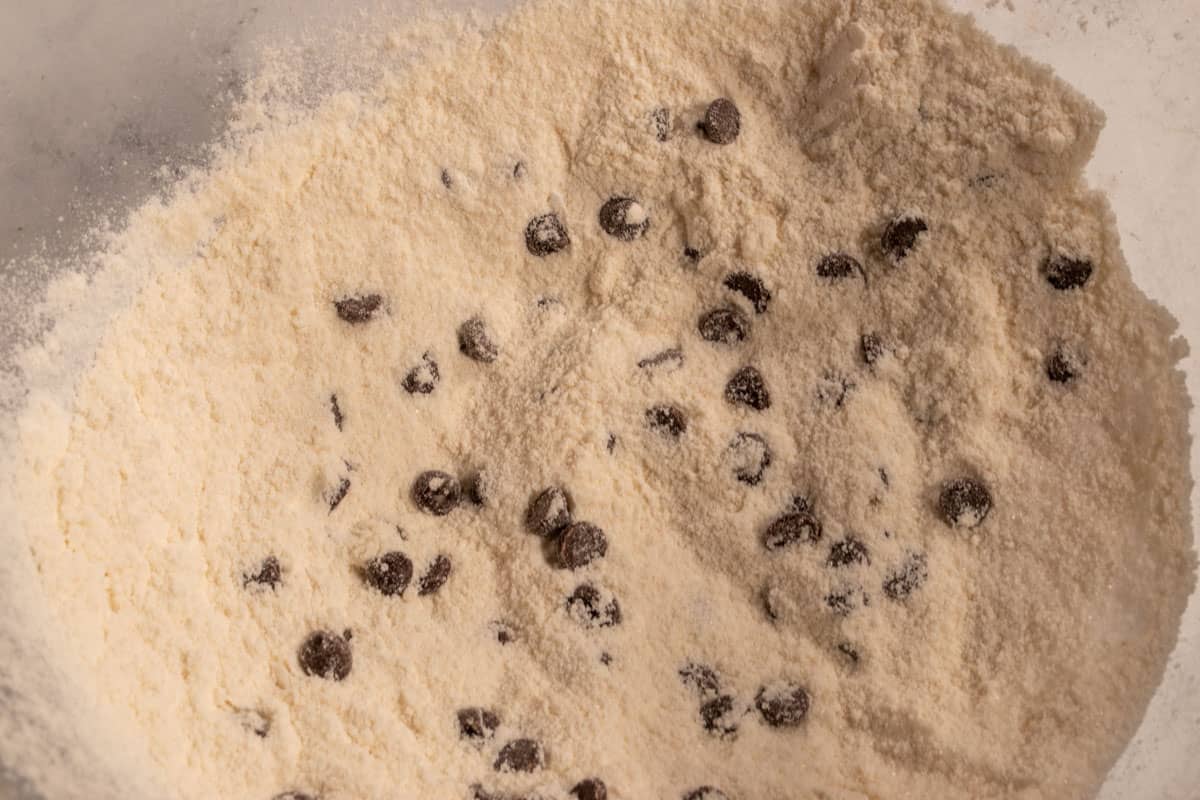 The dry cookie dough ingredients mixed together inside a bowl. 