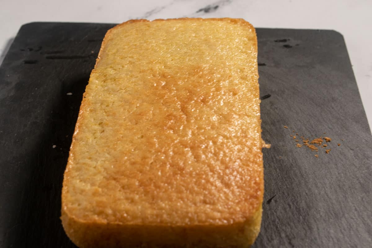 A whole, undecorated loaf of lemon cake. 
