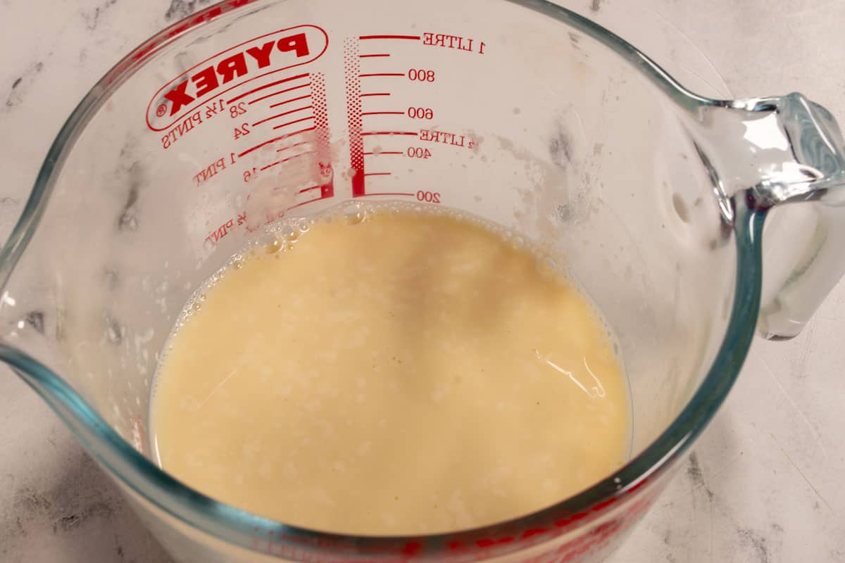The vegan buttermilk curdling inside a pyrex jug. 