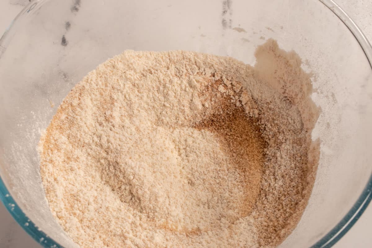 The dry ingredients combined inside a large glass mixing bowl. 