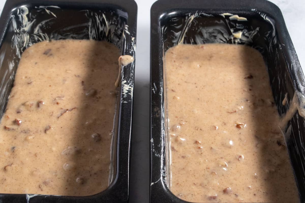 The cake batter has been poured into the prepared tins.