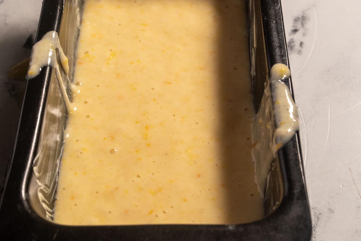 The smooth batter has been poured into the cake tins. 