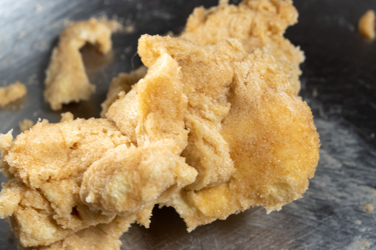 The butter and sugar creamed together inside a metal mixing bowl. 