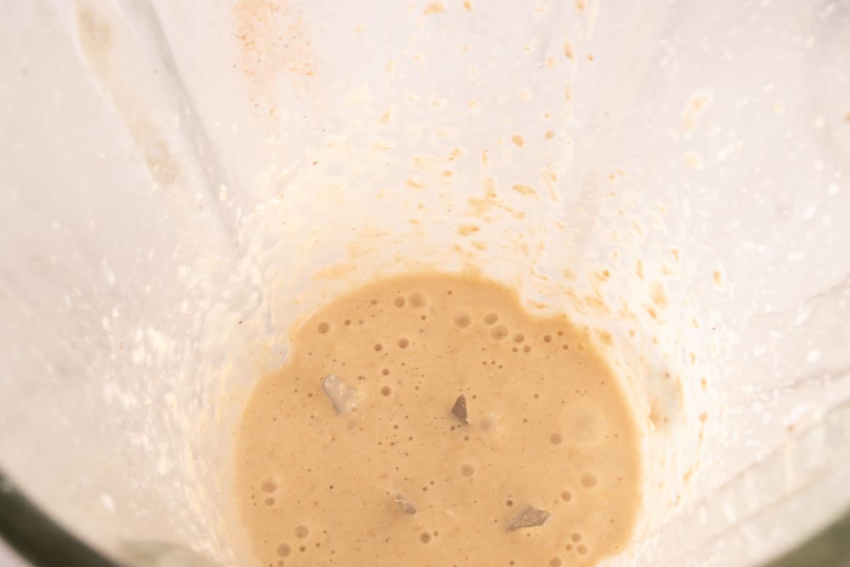 The oatmeal ingredients being blended together inside a high-speed blender. 