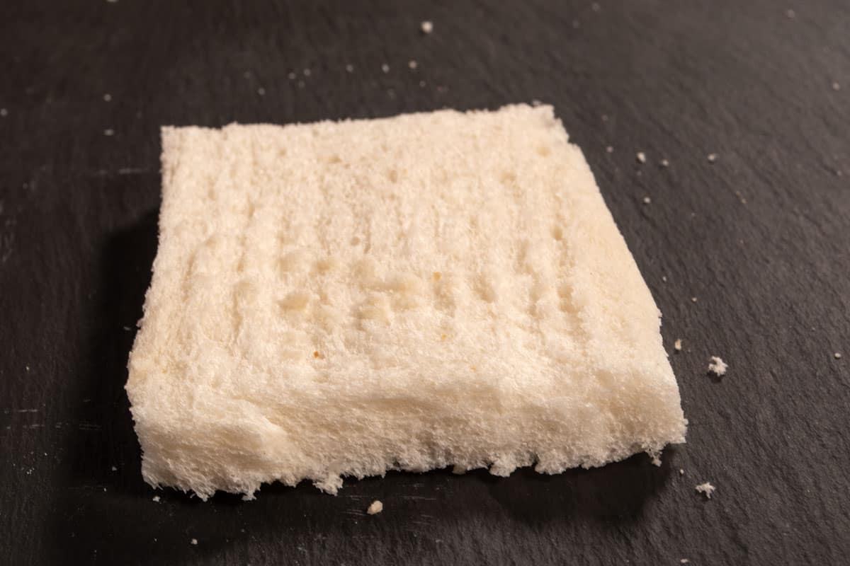 A slice of white bread with the crusts sliced off. 