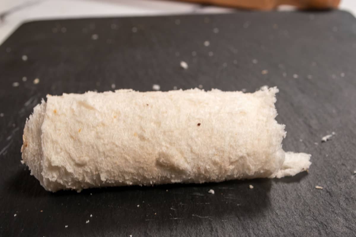 A rolled up chocolate french toast roll, waiting to be dipped into the batter. 