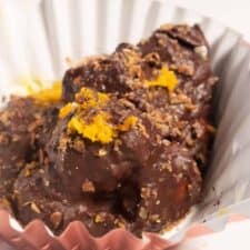 One of my macadamia nut clusters inside a cupcake case and covered with orange zest.