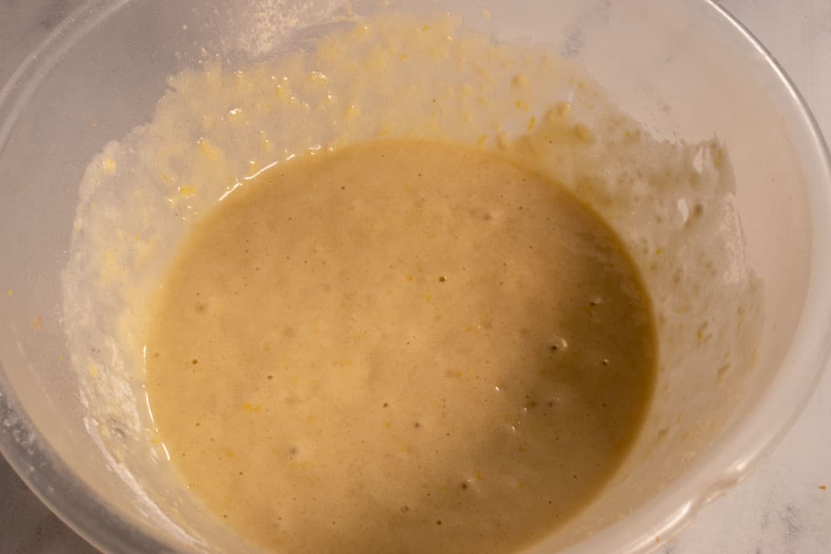 The wet ingredients have been added into the mixture to form a smooth batter. 