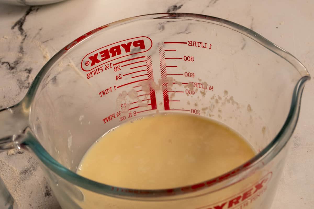 Vegan buttermilk curdling inside a pyrex measuring jug. 