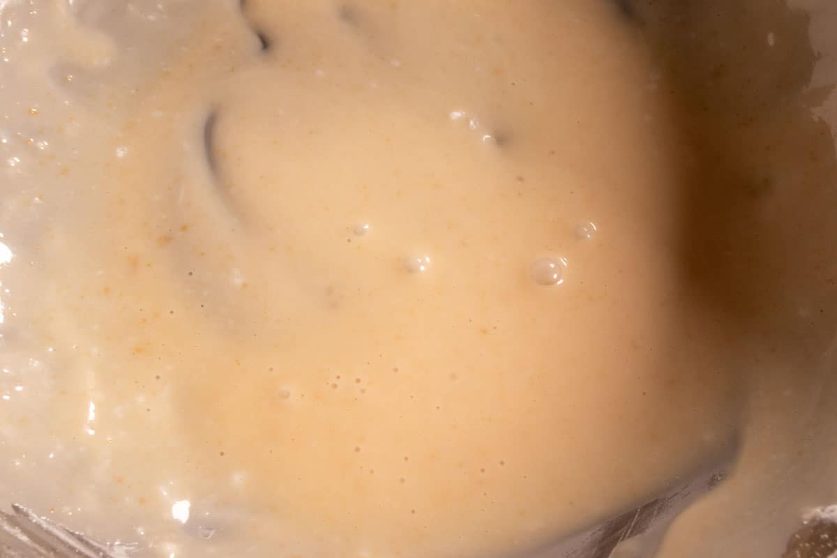 Peanut butter glaze inside a large mixing bowl, ready to go onto the cakes. 