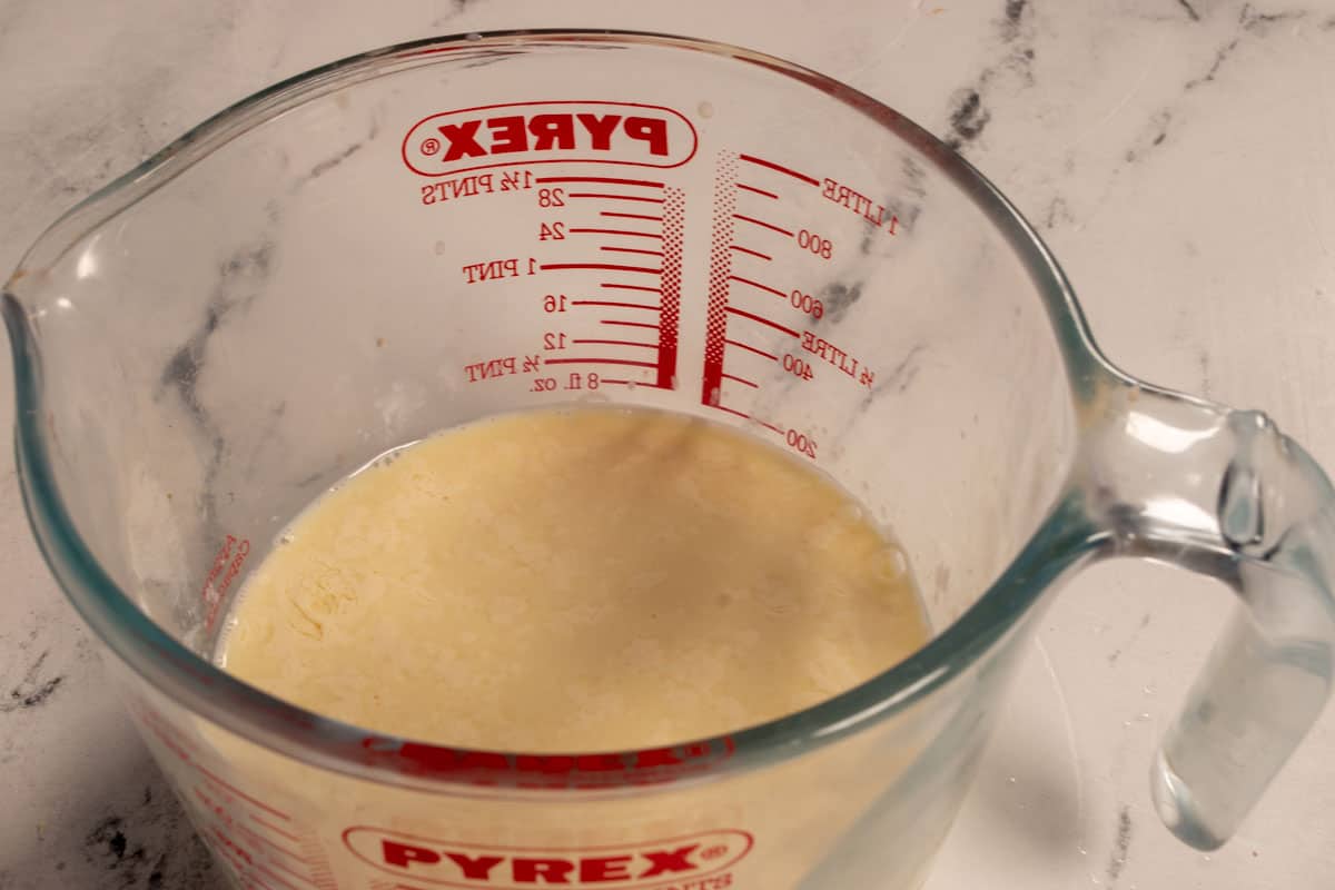 The vegan buttermilk curdling inside a big, glass measuring jug. 