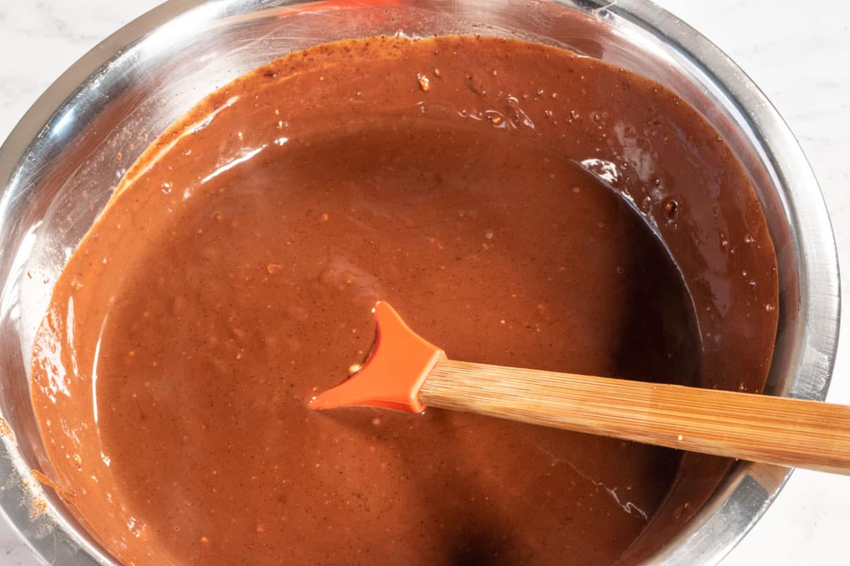 The melted hazelnut chocolate mixture inside a mixing bowl. 