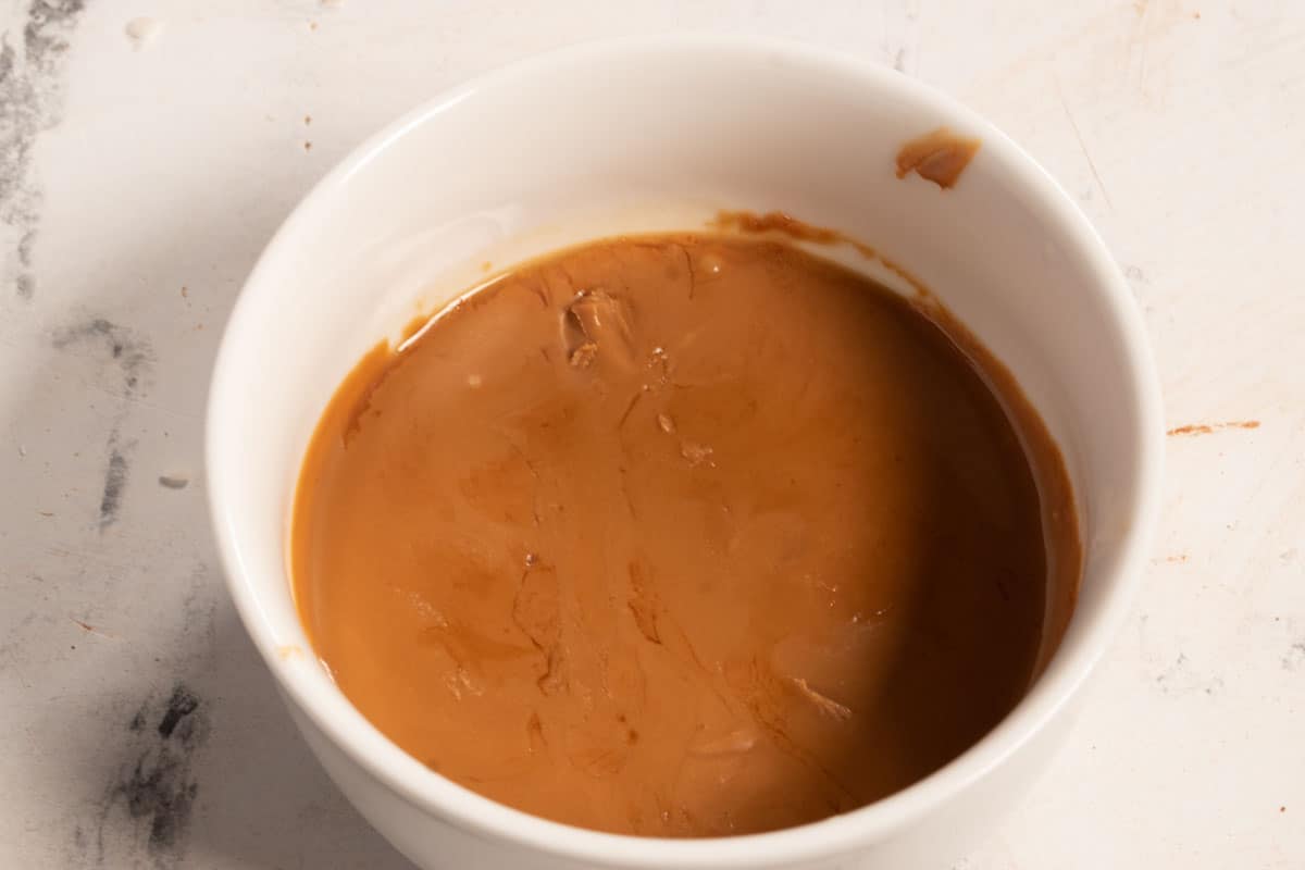 Biscoff spread melted inside a large ramekin.