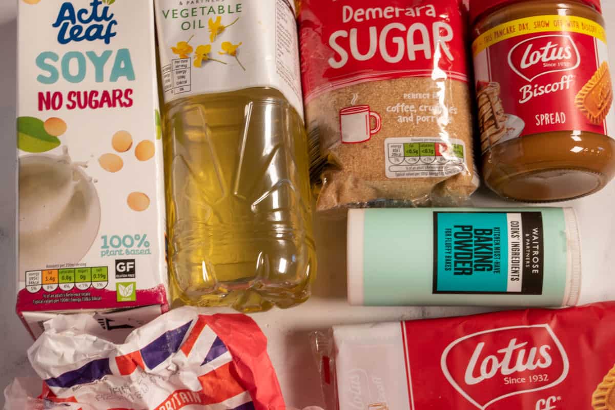 The recipe ingredients that you will need to make my vegan biscoff mug cake laid out over a white marble background.