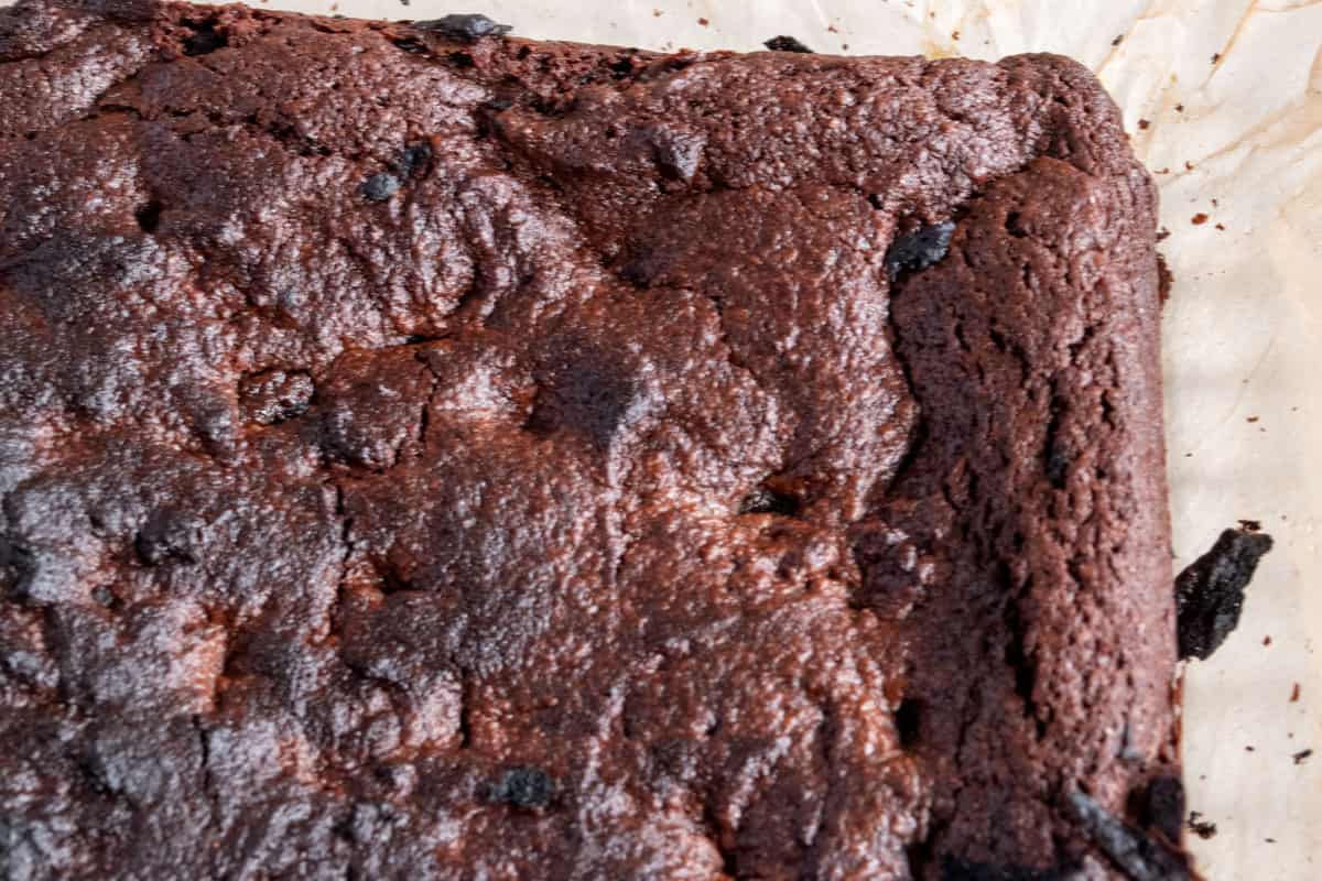 The brownies have been baked in the oven and are cooling on a white board. 
