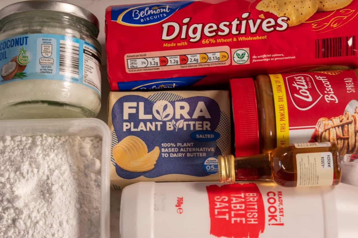 The recipe ingredients that you need to make my cookie butter bars, all laid out over a white marble background.