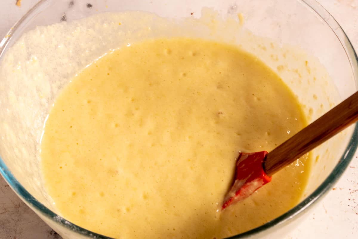 The lemon cake batter has been made and sits inside a large bowl. 