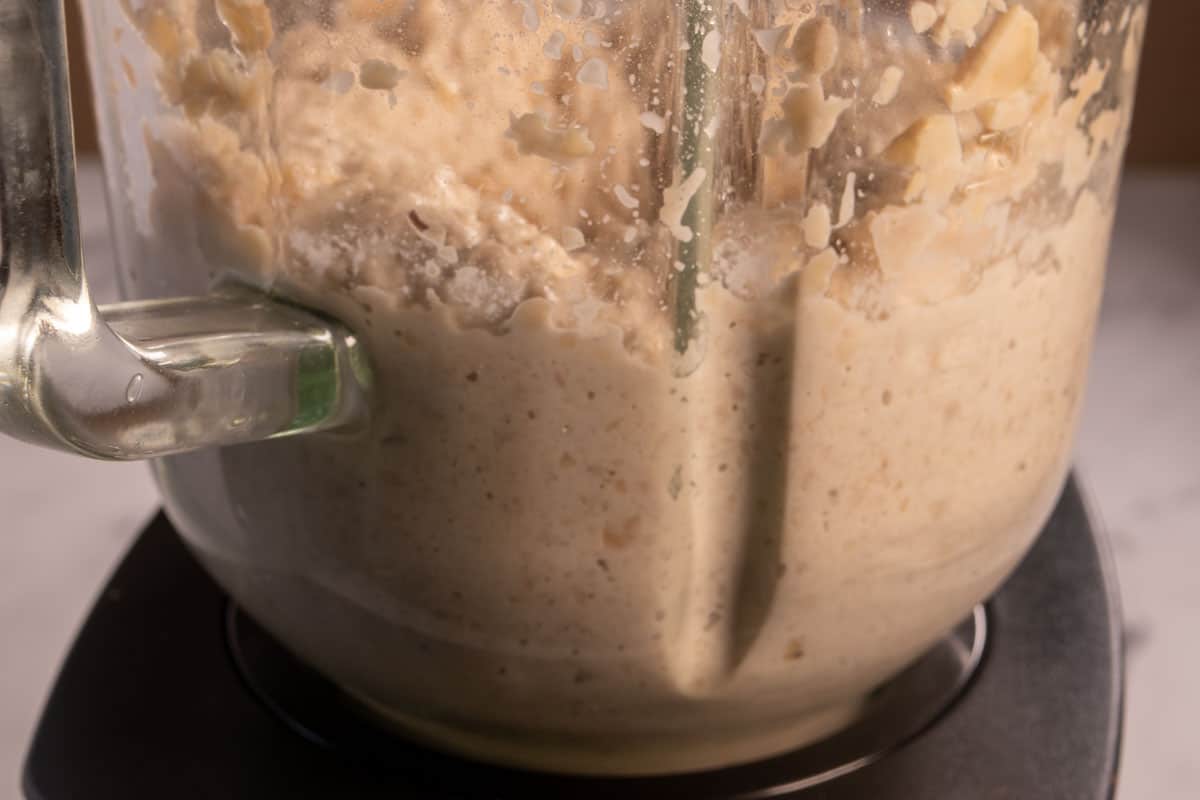 The cashews being blended with some water. 