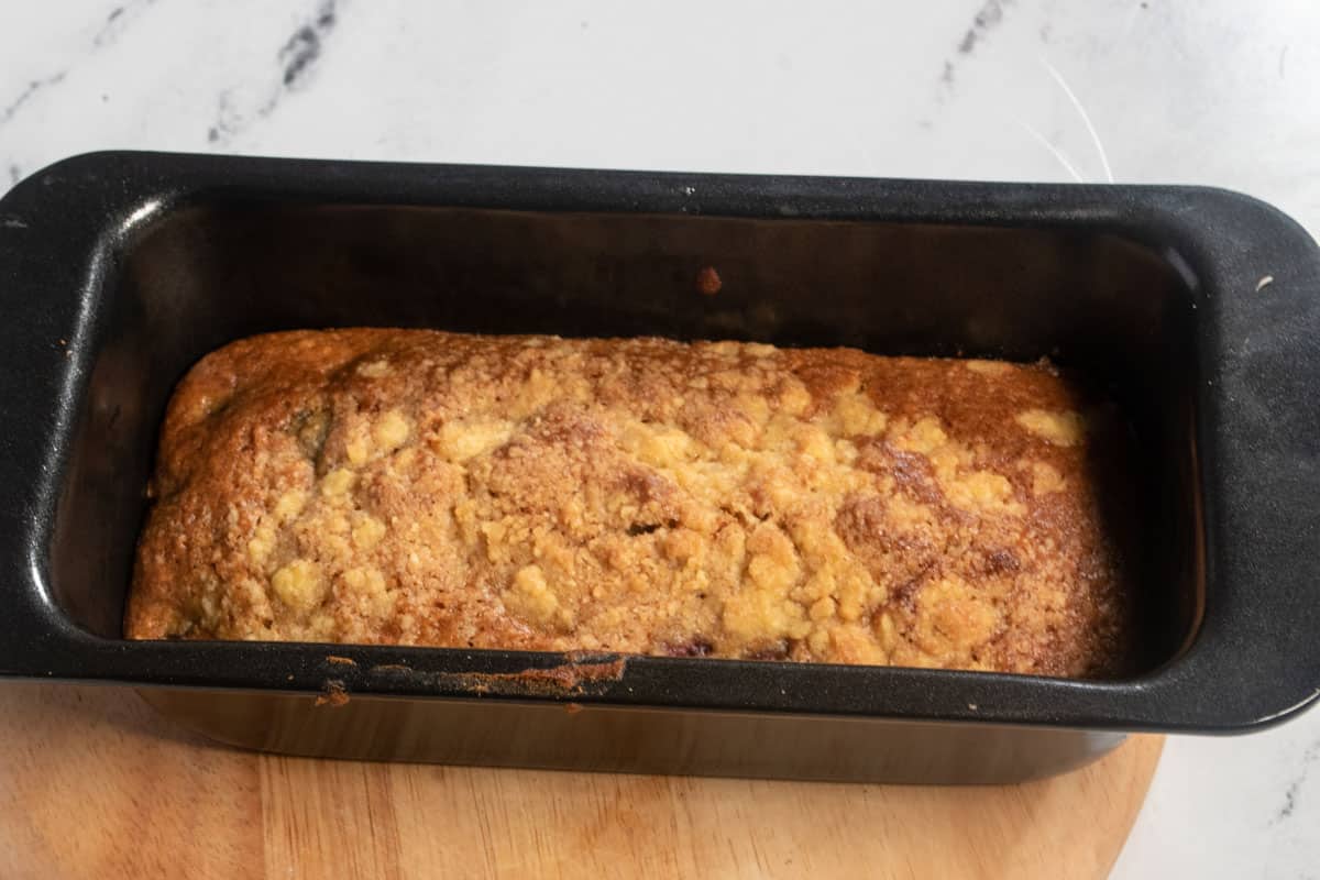 A cooked loaf cake cooling in the tin. 