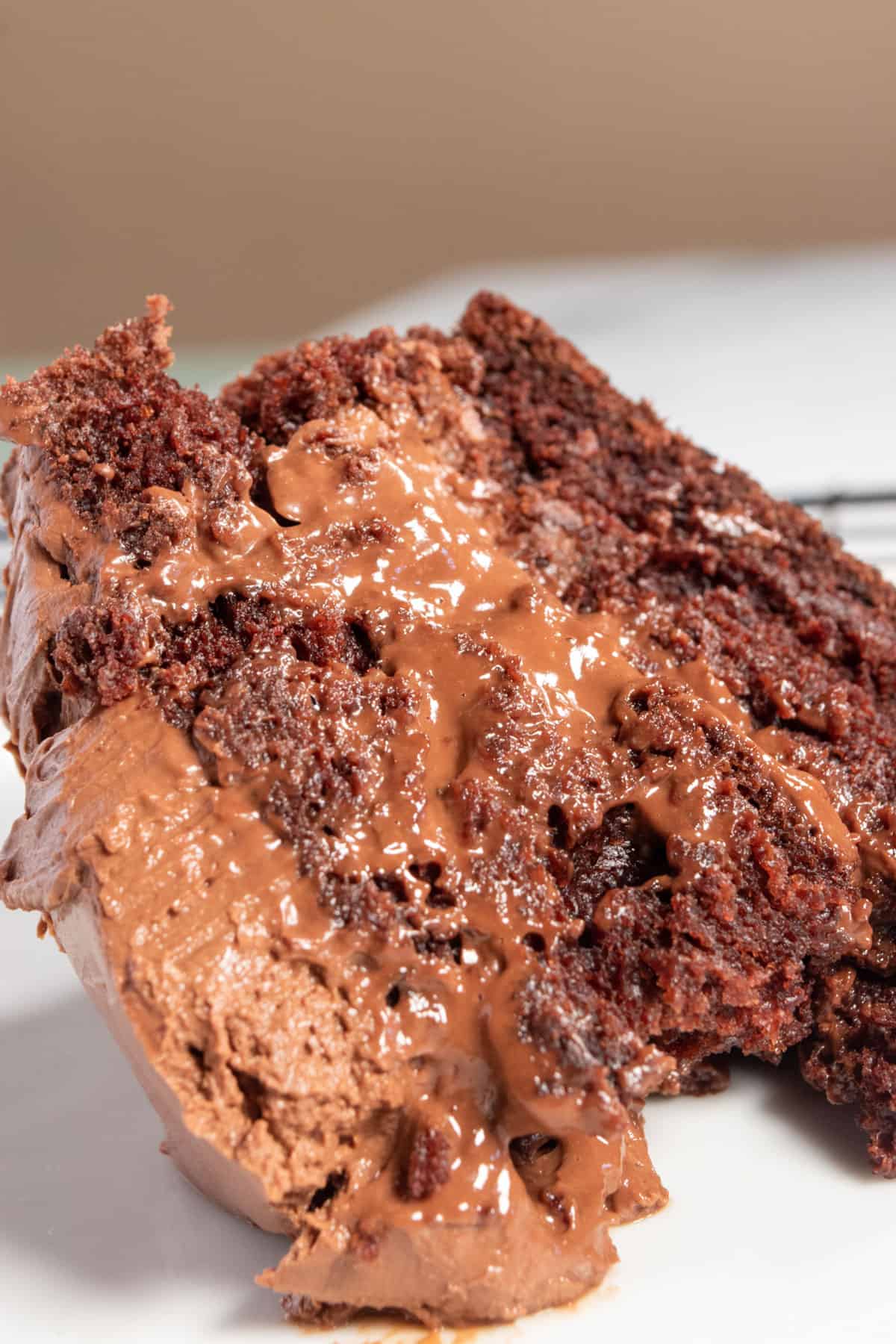 A gooey piece of cake topped with a thick layer of chocolate mousse. 