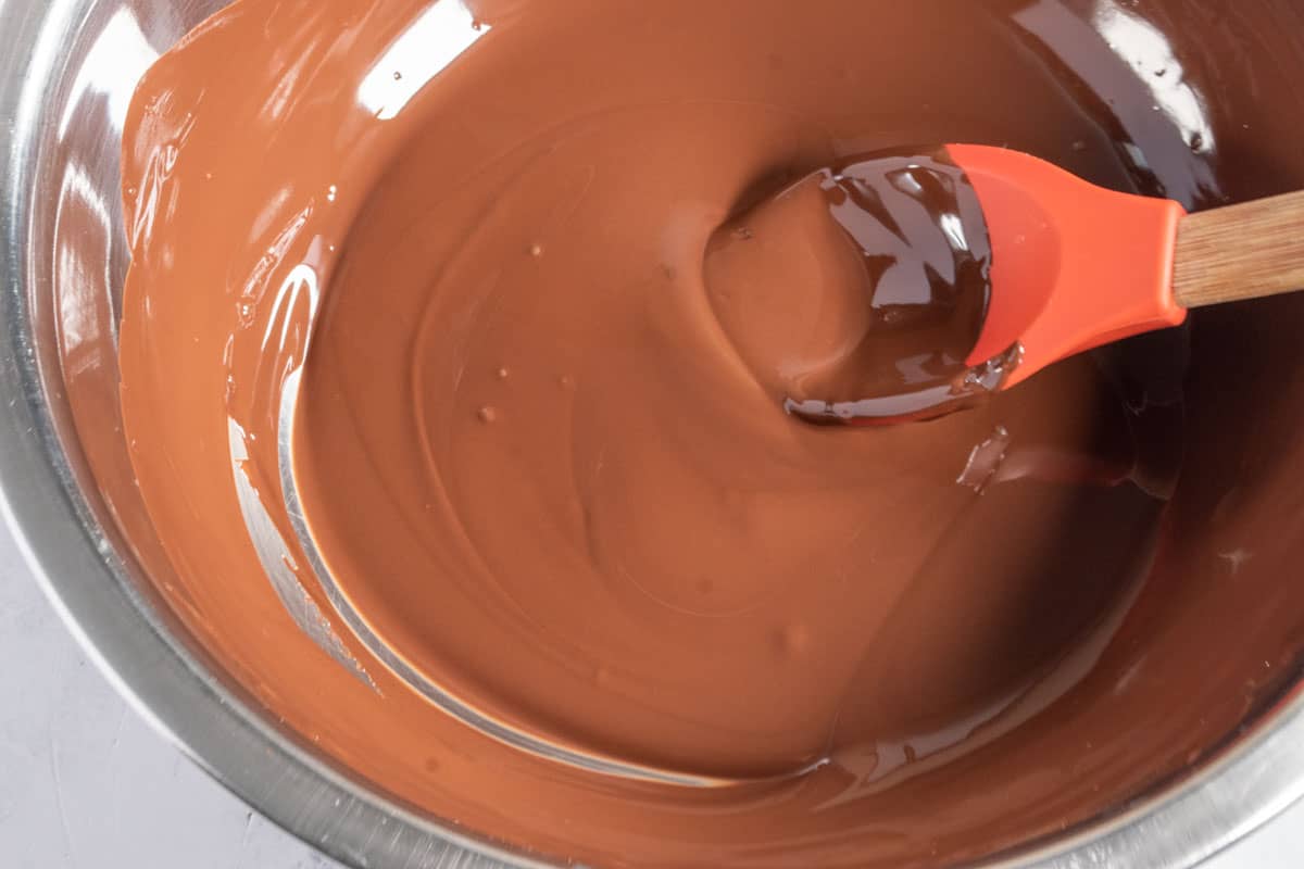 Chocolate being melted inside a heatproof bowl. 