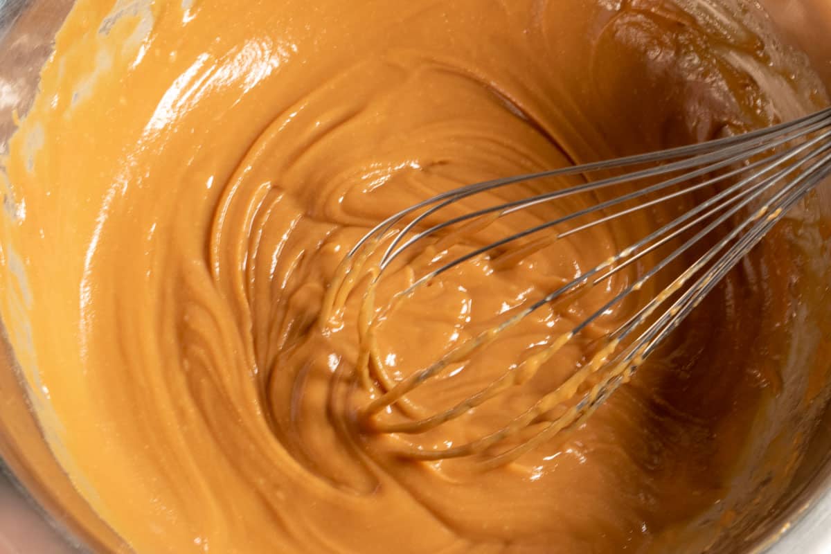 The peanut butter filling being whisked together inside another large bowl. 