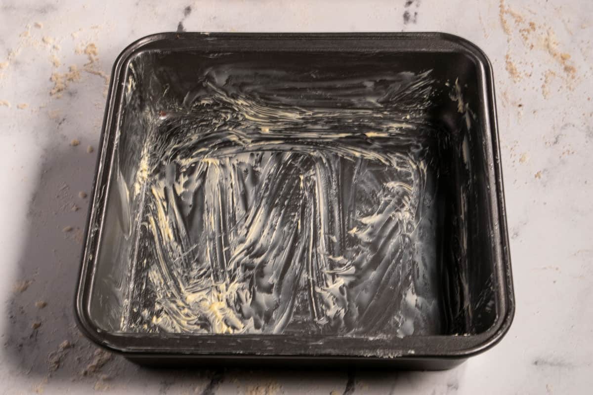 A greased, square baking tin. 