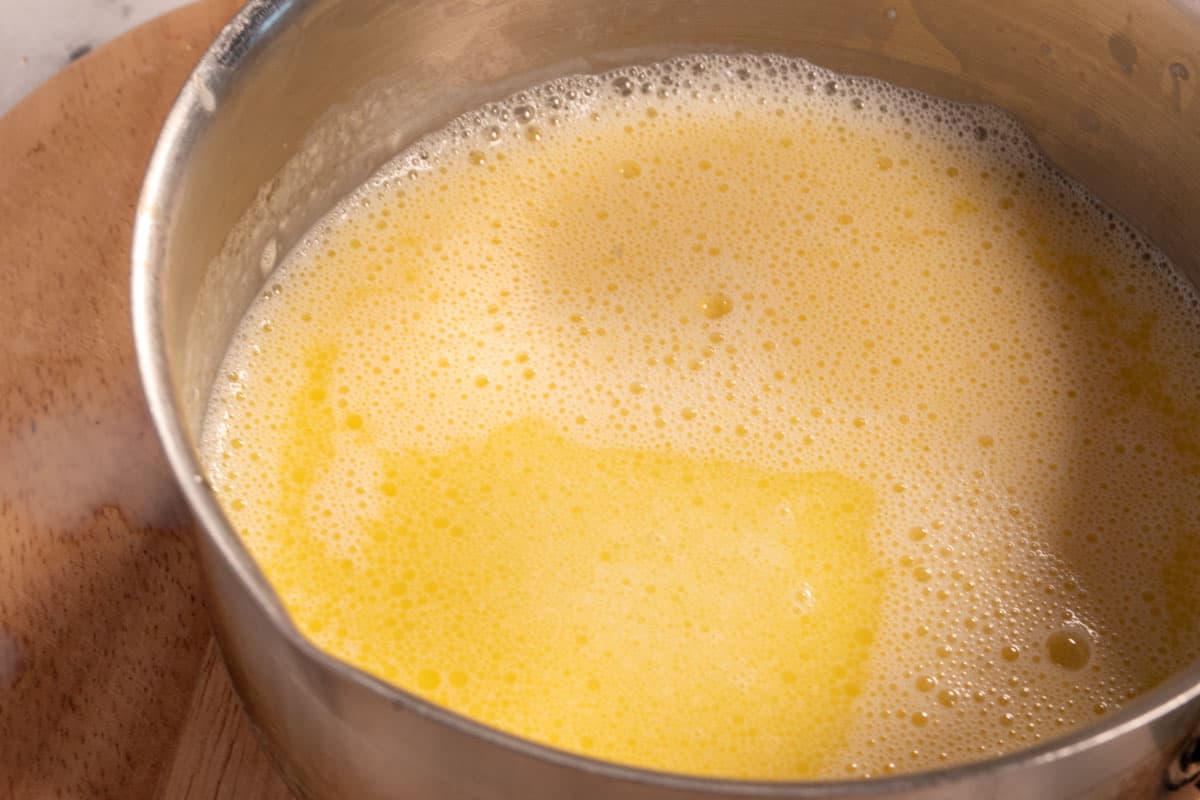 The wet ingredients, including the warm soy milk inside a small pan. 