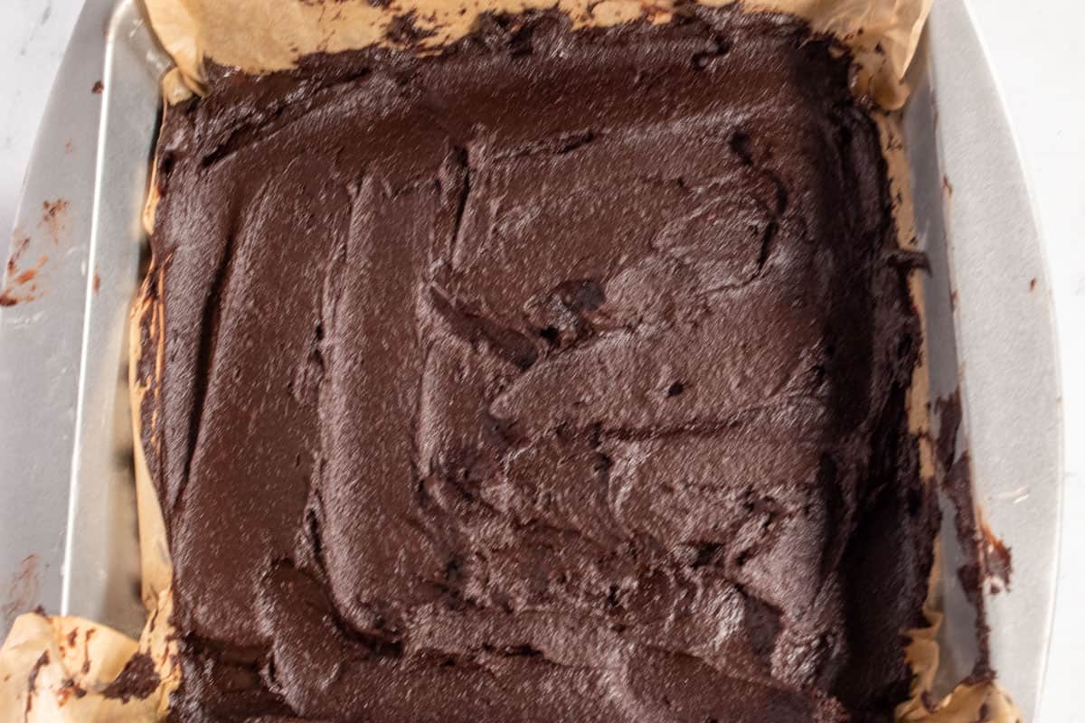 The brownie batter has been spooned into baking tray and smoothed out. 