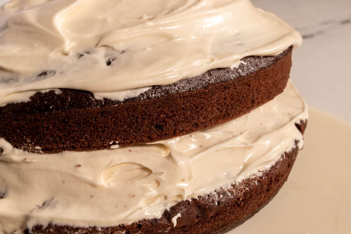 The coffee cream filling has been spread onto the vegan tiramisu cake as well as the topping. 