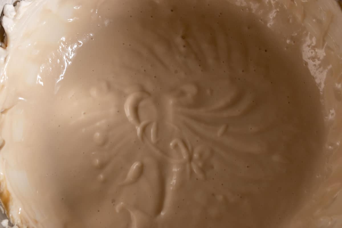 The dulce de leche cream filling being prepared inside a stand mixer bowl.