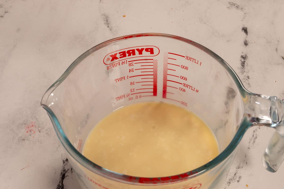 Vegan buttermilk curdling inside a large pyrex jug. 
