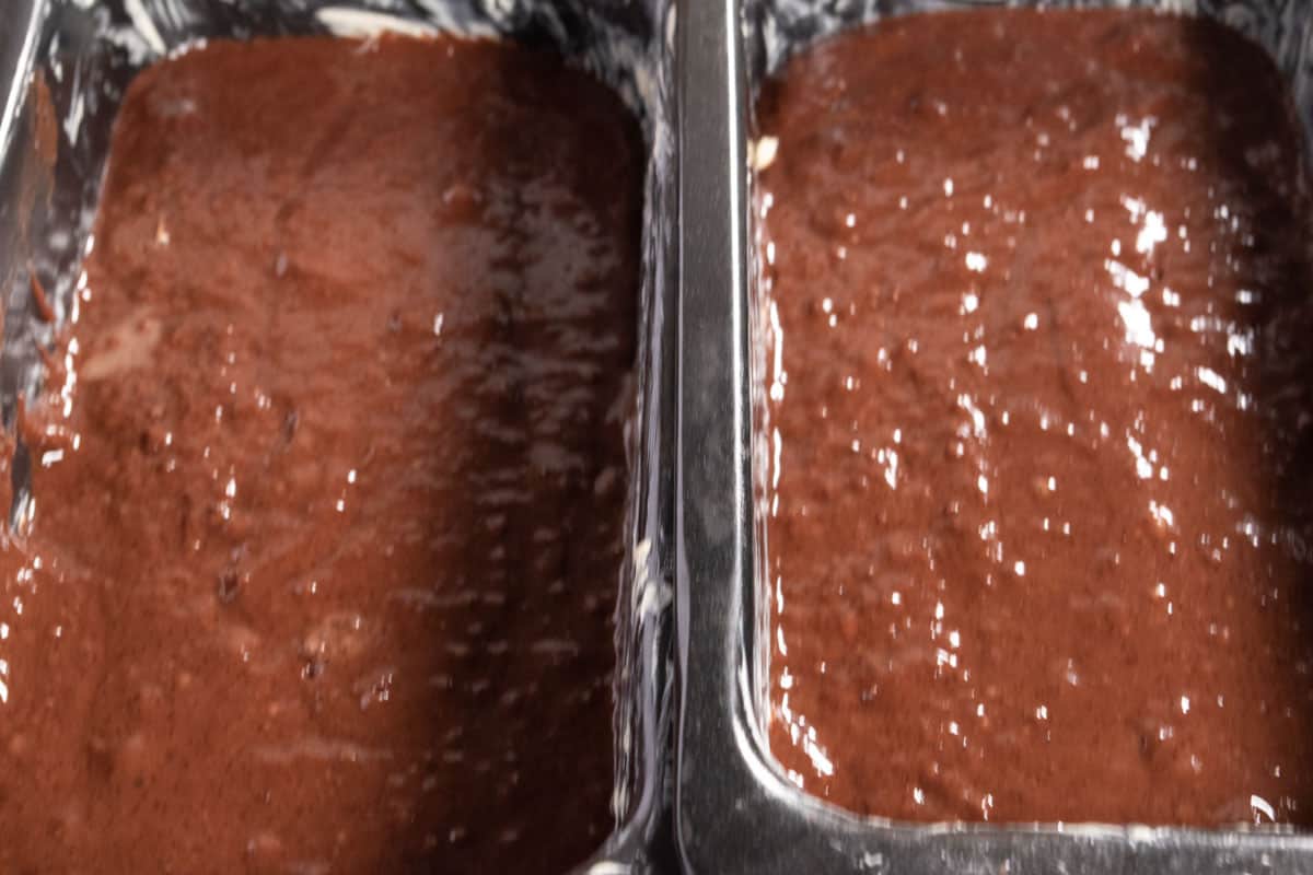 The cake batter has been poured into the two loaf cake tins. 