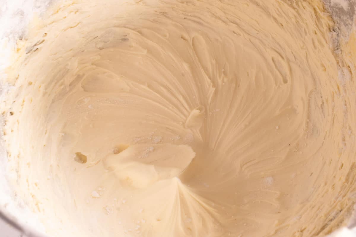 The vegan buttercream frosting has been made inside a large stand mixer. 
