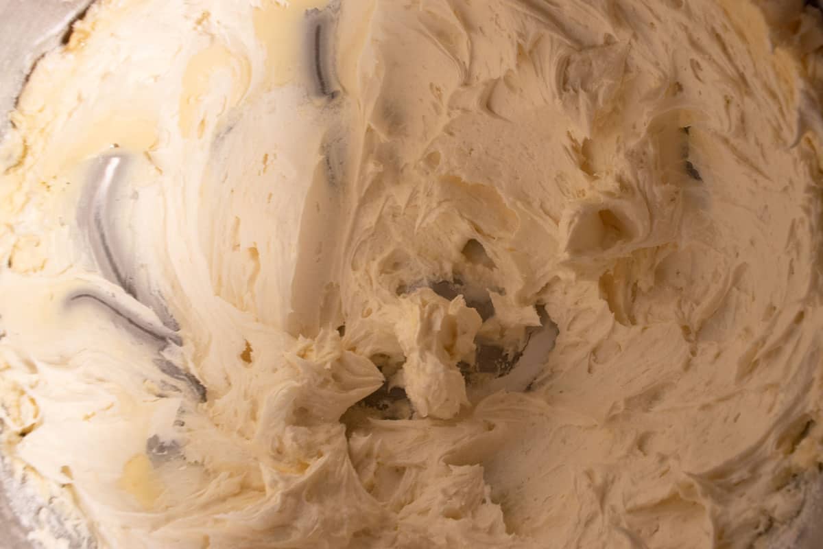 The frosting inside a large stand mixer bowl. 