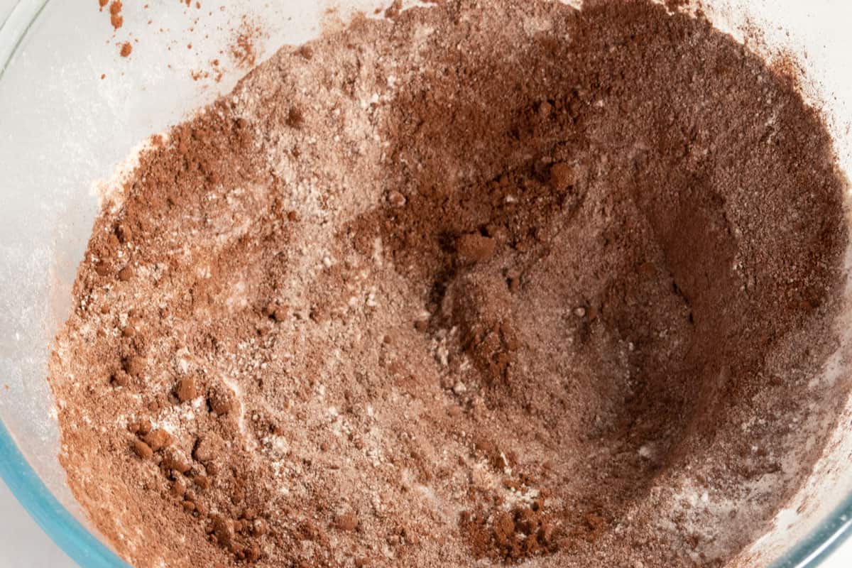 The dry chocolate cake ingredients combined inside a large bowl. 