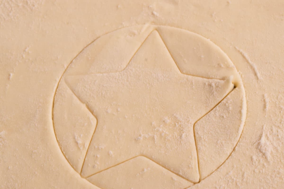 The pastry shapes have been cut out on the puff pastry dough.