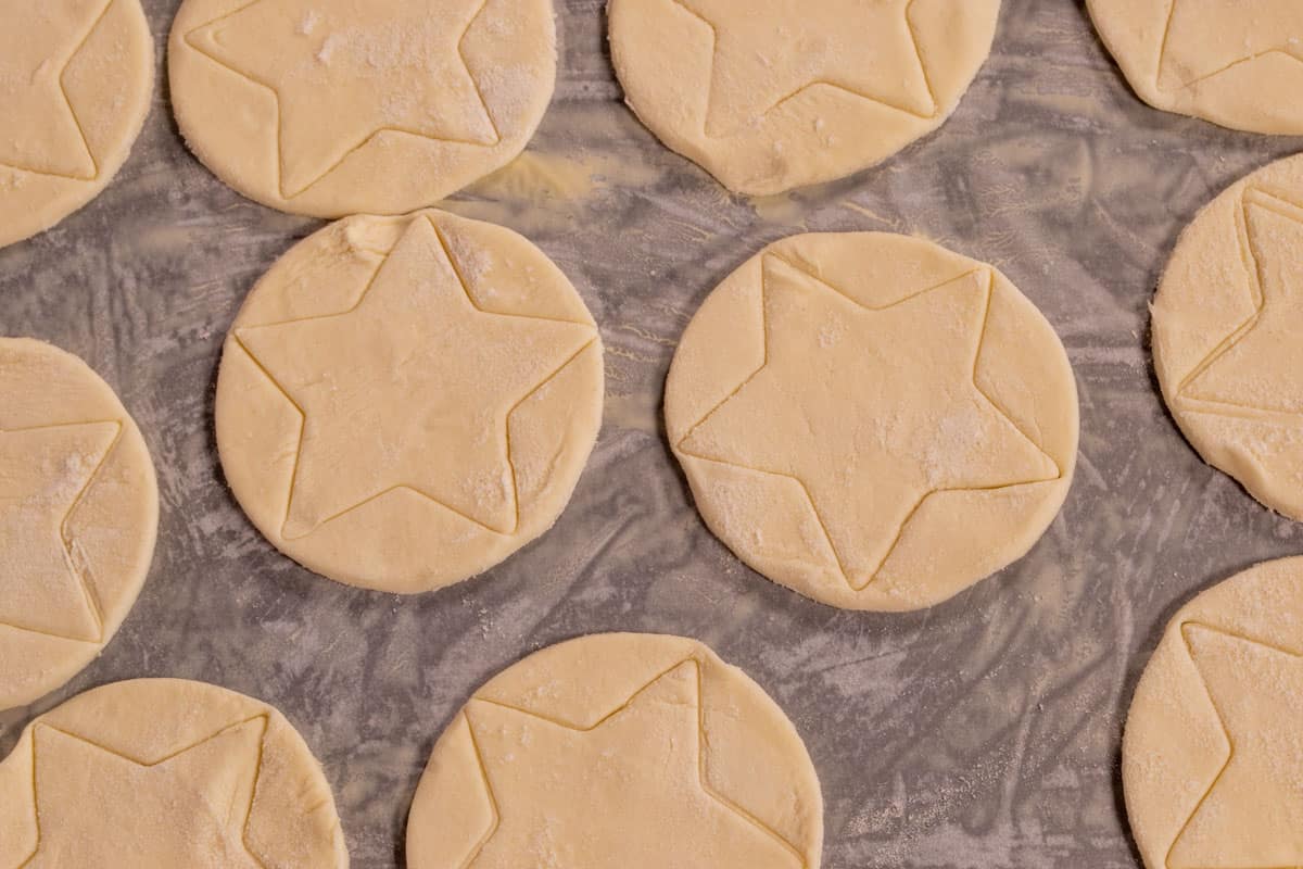 The cut out pastry has been placed onto the lined baking sheet. 