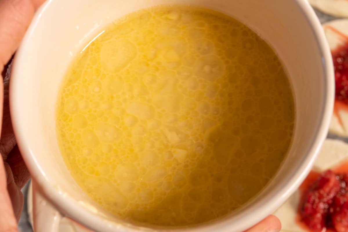 The vegan 'egg' wash inside a large ramekin being shown to the camera. 