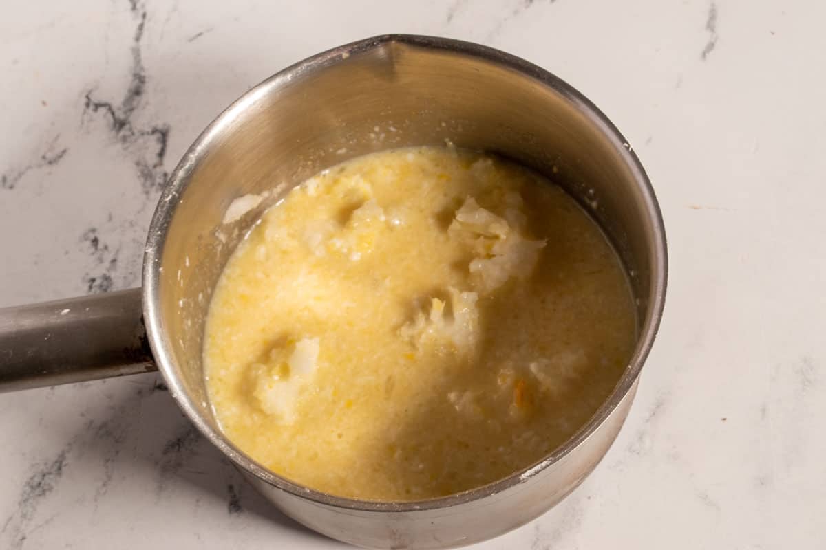 The wet ingredients have been added to the pan, creating a dark yellow colour. 