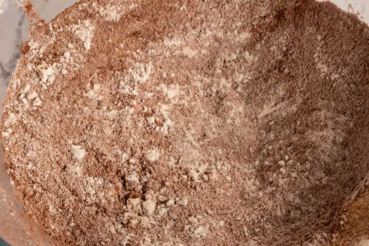 The dry chocolate cake ingredients mixed together inside a mixing bowl.