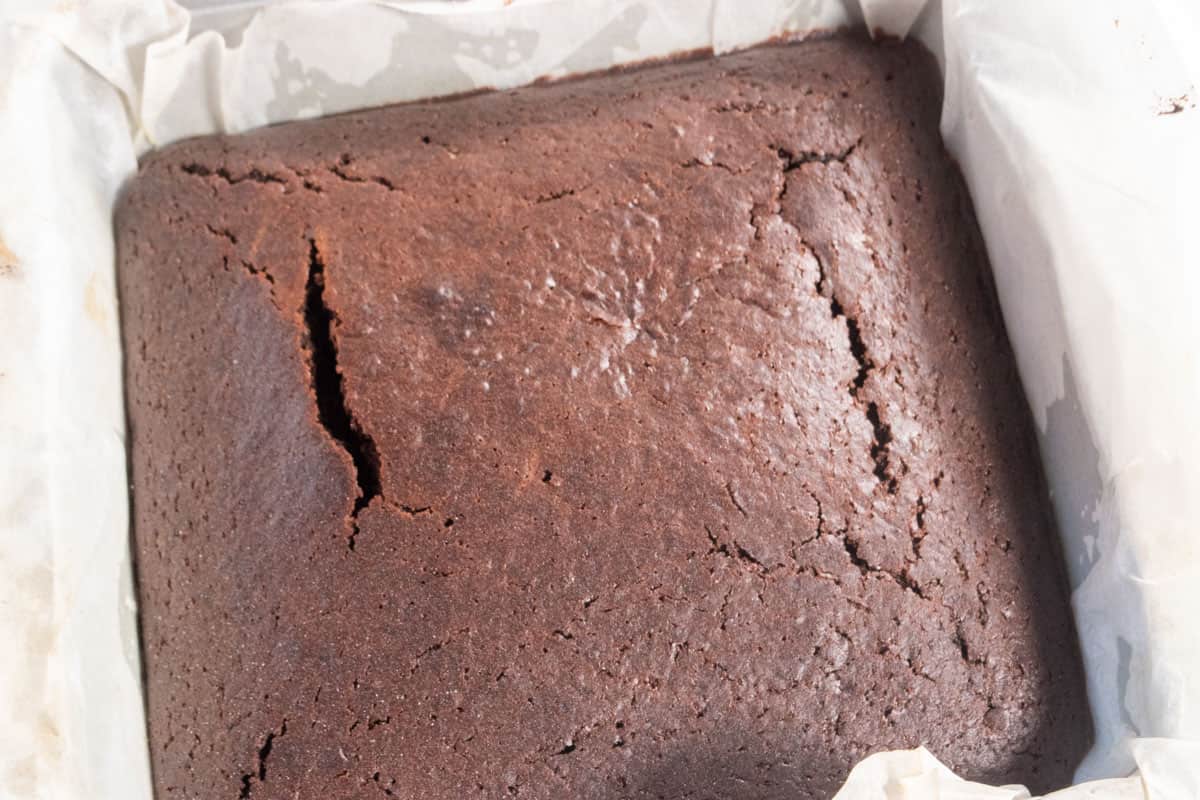 The chocolate cake has been baked and is cooling down inside the tin. 