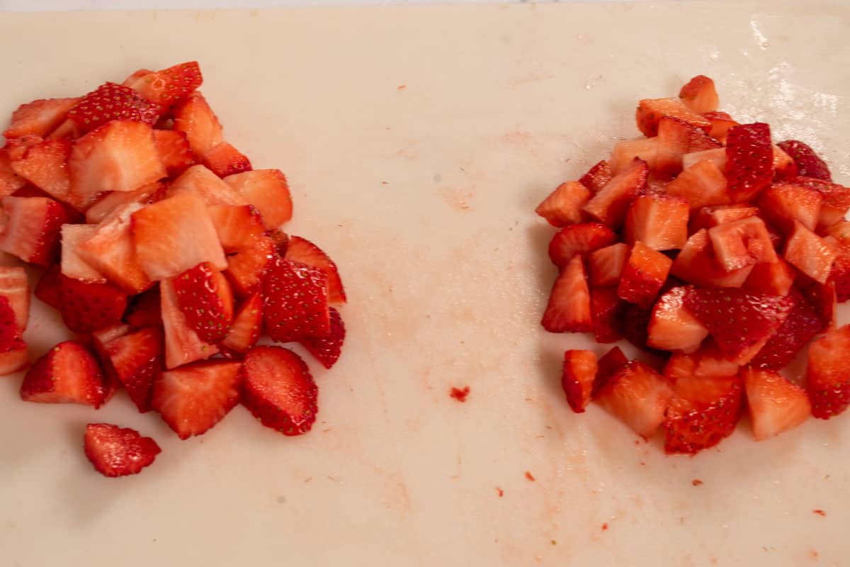 The strawberries have been sliced and placed into two piles. Some for the filling and the rest for the topping. 