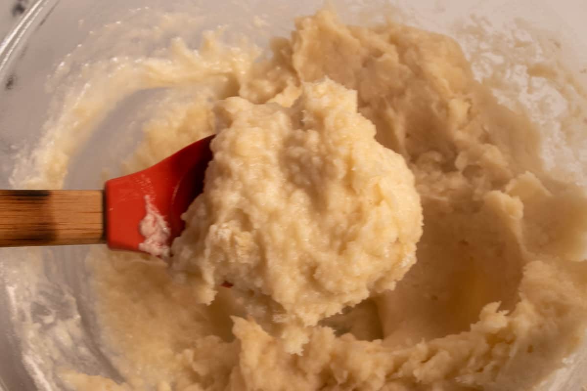 The flour has been added to the wet ingredients, creating a churro batter.