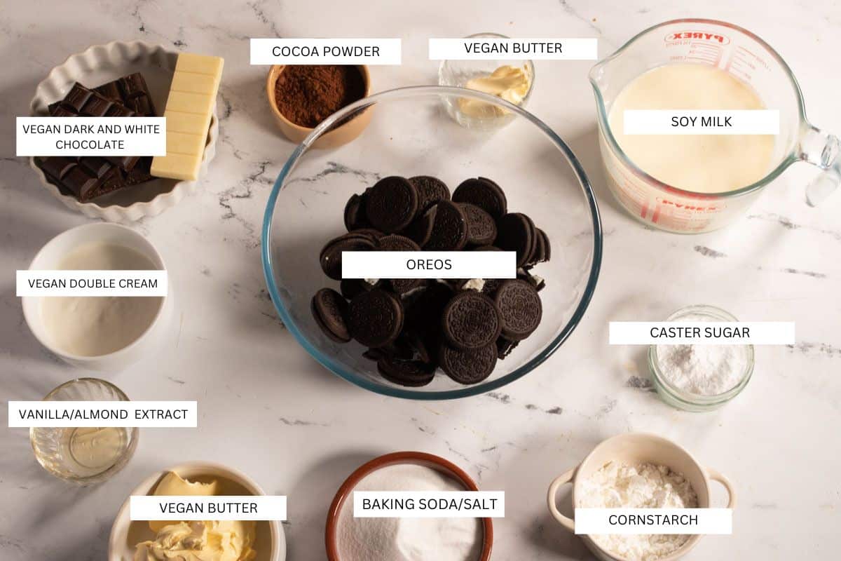 The required ingredients for making vegan chocolate pudding pie laid out neatly over a white marble background. 