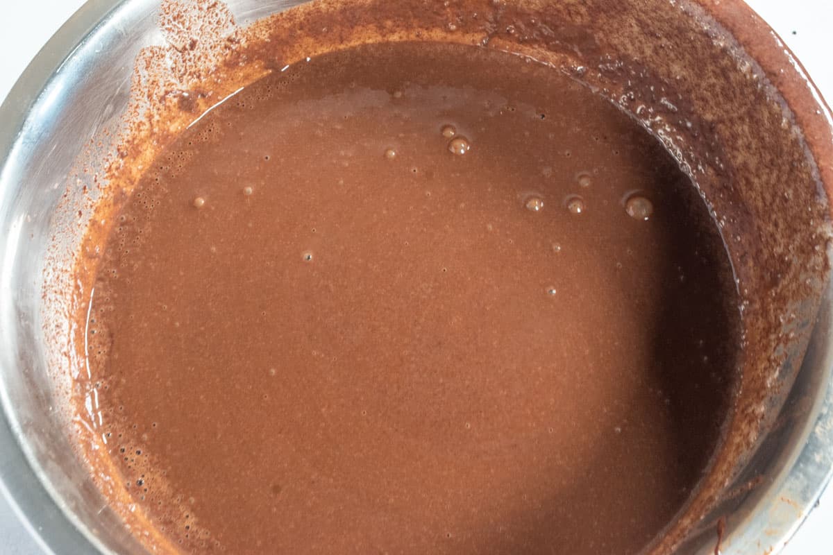 The dry and wet ingredients have been combined, creating a thick chocolate mixture. 