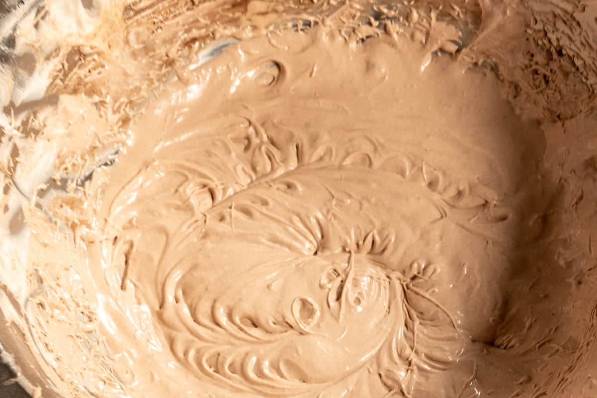 The chocolate whipped cream inside a stand mixer bowl. 