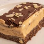 A large, rectangular-shaped slab of my vegan nanaimo bar custard slices. The custard layer is creamy and thick.